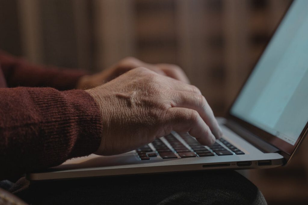 pexels photo 5710516 Close-up of hands typing on a laptop keyboard, ideal for business and technology themes.